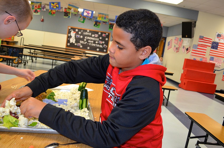 Cameron Holding puts the final touches on his team's project.