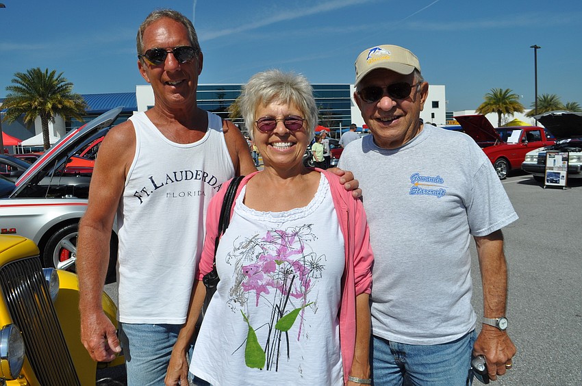 Tom Robinson, Patty Robinson and Chet Grudzien enjoy perusing the rows of vehicles.