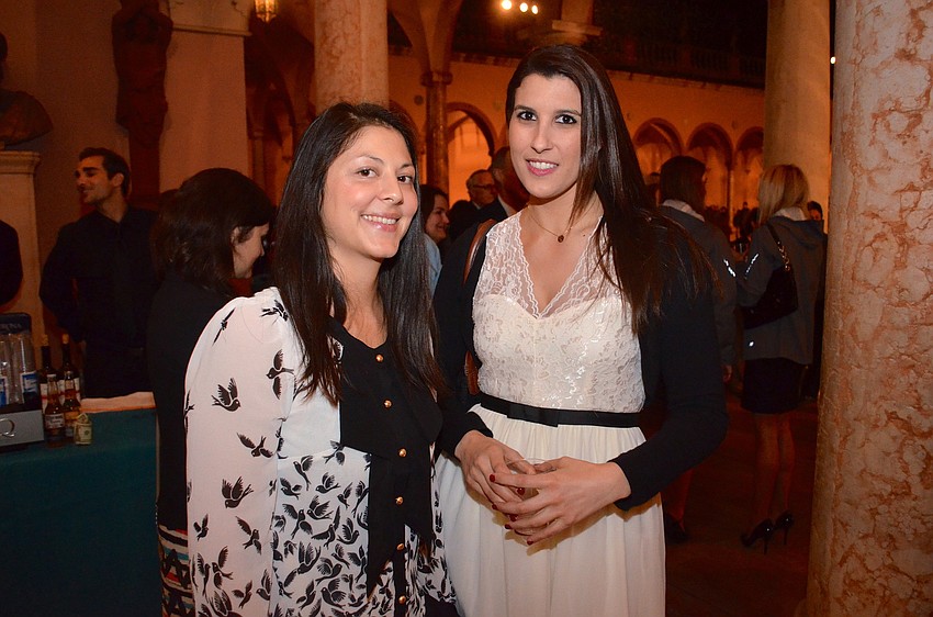 Pagona Chronopoulos and Corralie Kreidel sip cocktails after the teams marched through the courtyard.