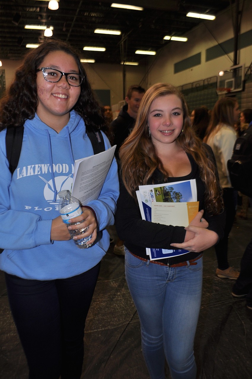 Isabella Ortiz and Elena Pagan look at college programs.