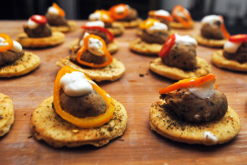 Libbyâ€™s CafÃ© and Barâ€™s black eyed pea hummus, Tzaiki sauce and baby bell pepper salad on a pita point