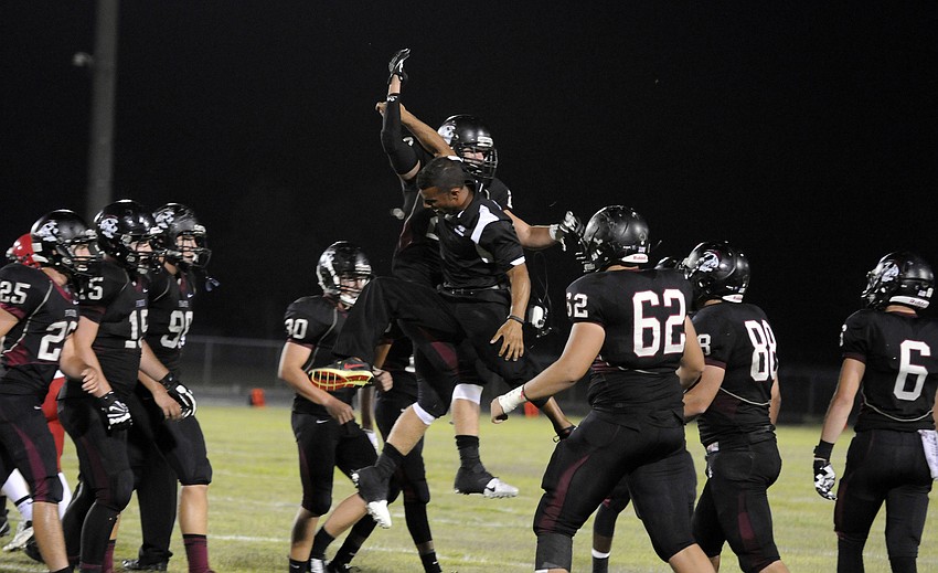 Braden River coach Curt Bradley celebrates with linebacker Chase Balliette and the rest of the Pirates defense following a muffed field goal attempt.