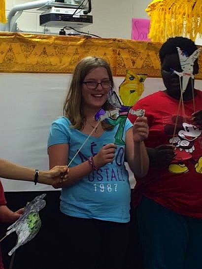 Anabela Burns smiles as she performs with her puppet.