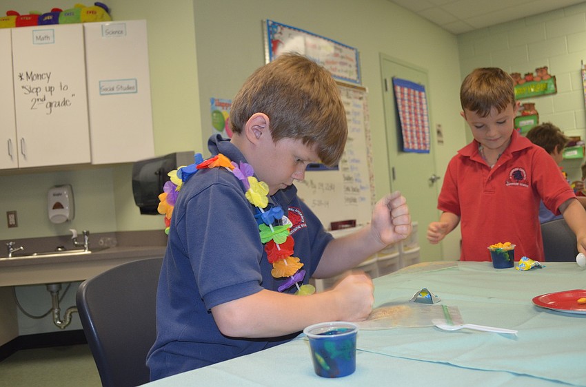 Zachery Gibson crushes graham crackers for his sea-themed snack.