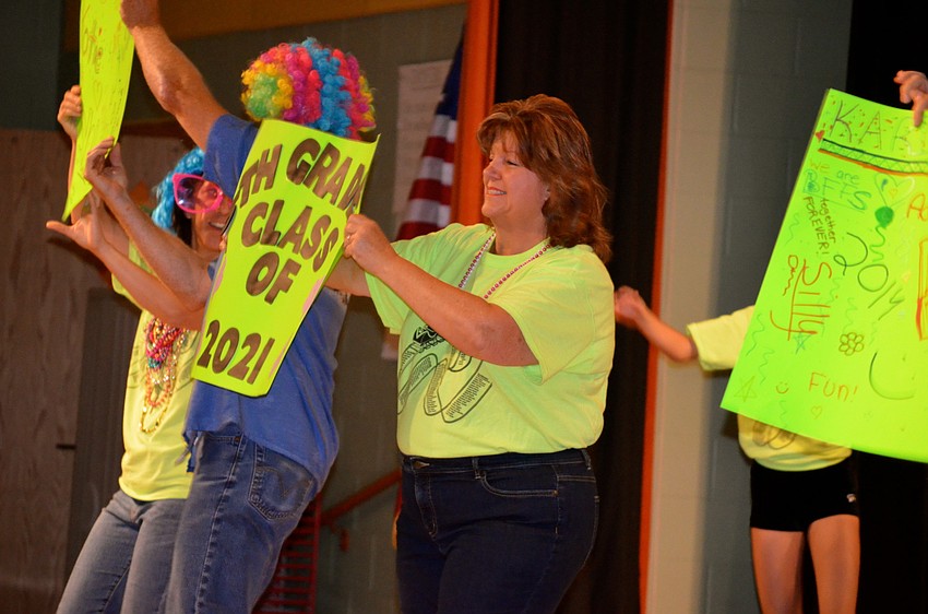 Kathy Kines, a fifth-grade teacher, dances with her class.
