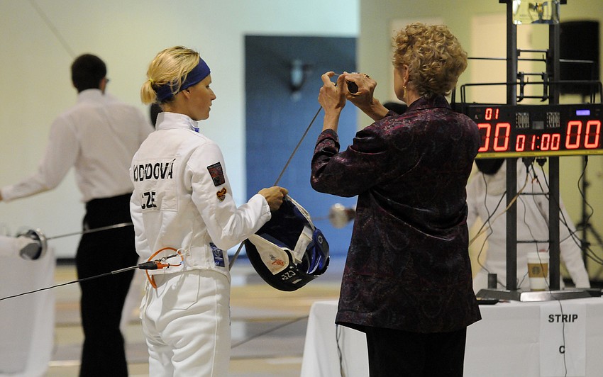 Barbora Kodedova of the Czech Republic has her sword examined before the start of her bout.