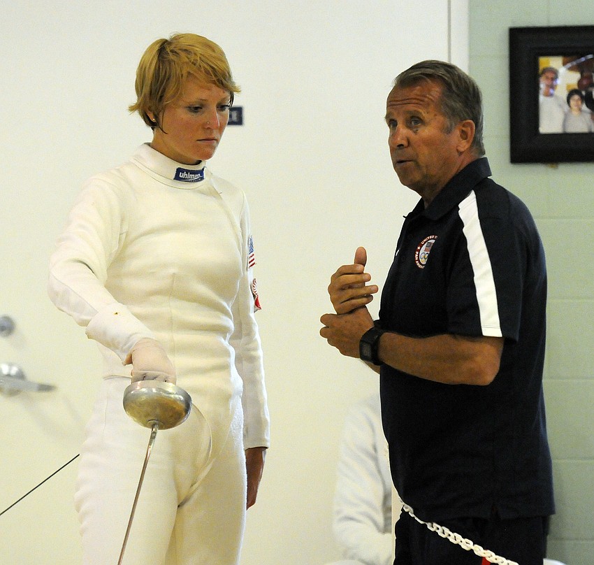 The United Statesâ€™ Margaux received advice from her coach before taking the piste for her next bout.