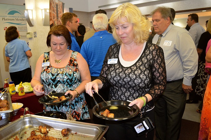 Michelle Nims and Toni Carroll decide which foods to eat.