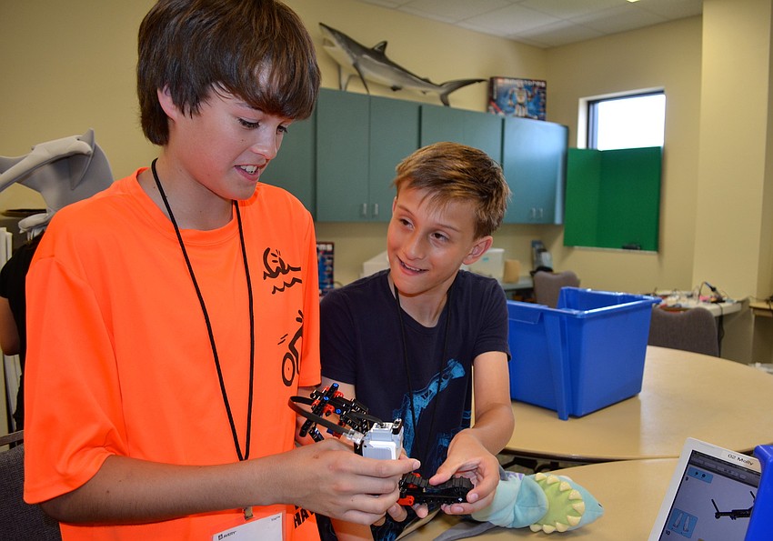 Jake Barrett, 12, and Elliot Radin, 11, explain how their robot will look when itâ€™s finished.