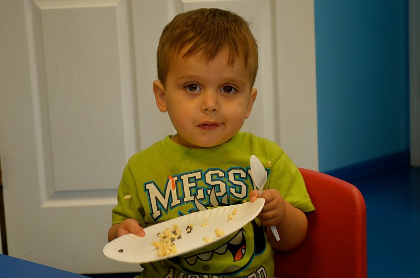 Mason Hahn gobbles up his snack.