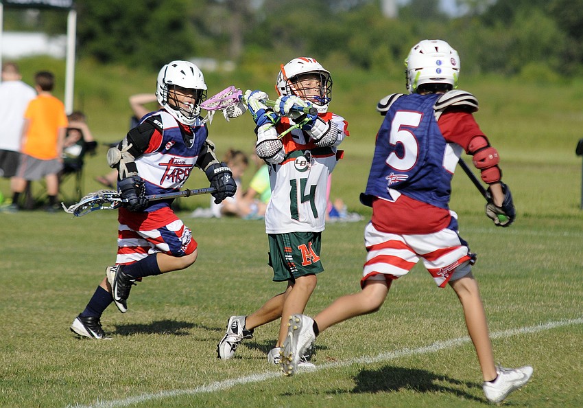 Ten-year-old Guy Panzer attempts to pass the ball over a LB3 Tarpons defender.