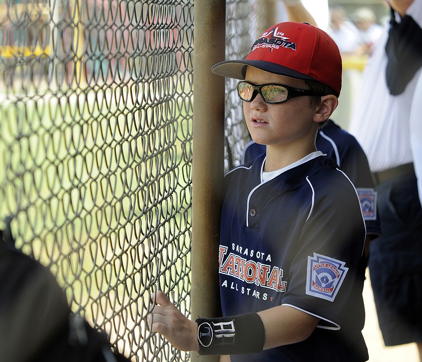 Scott Gordon cheers on his Sarasota National 9/10 teammates from the dugout during their game versus Sarasota American.