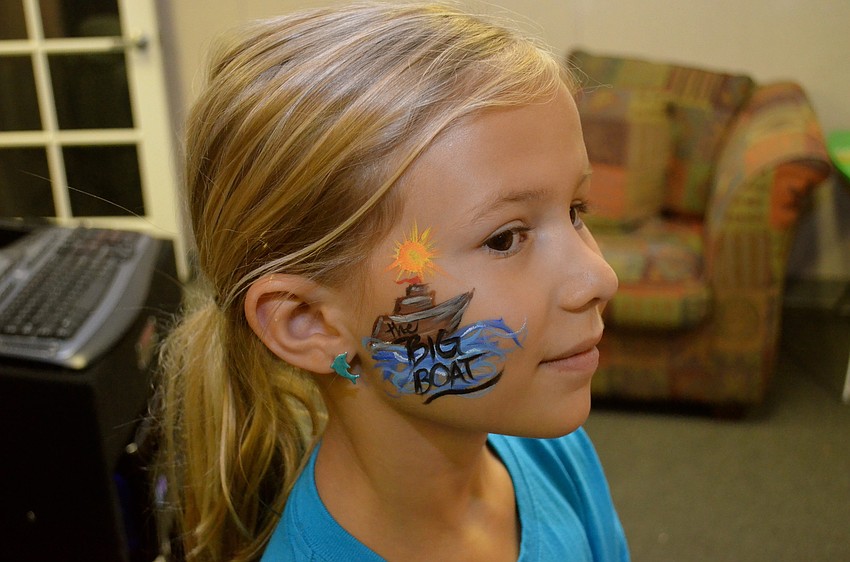 Isabella Bartman shows off her summer camp-themed face paint.