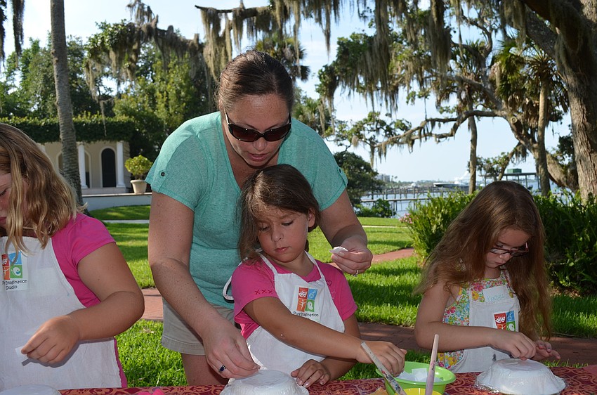 Pam Brownell helps Savanna Maroney with her bowl.