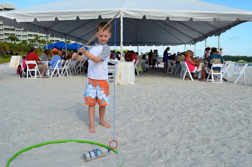 Cort Griffin plays the â€œUnited We Standâ€ game during the barbecue.