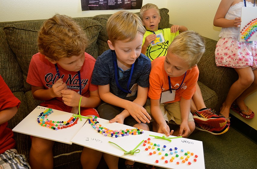 Luke Leonardis, Colin Epps and Dylan Johnson show off their artwork.