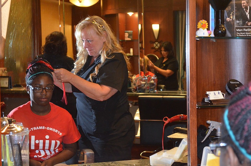 Shanerica Ward has her hair done by Sharyn McCormick.
