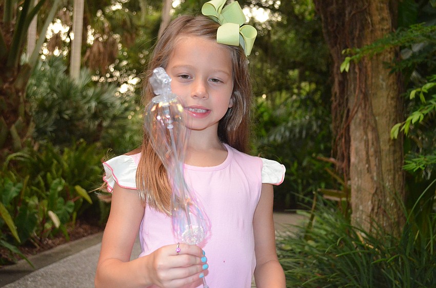 Hadley Lawrence plays with a wand.