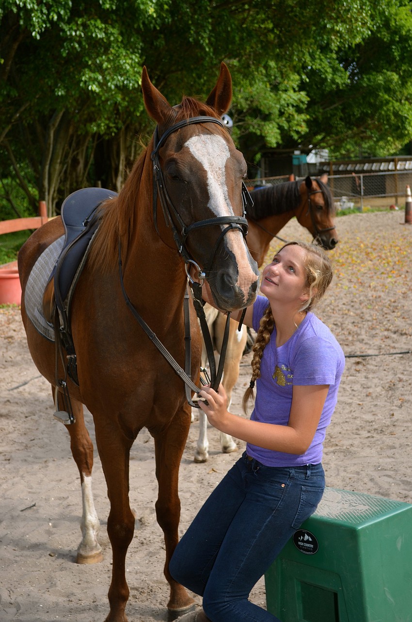 Corinna Kuschnitzky takes a break with her horse, Surprise.