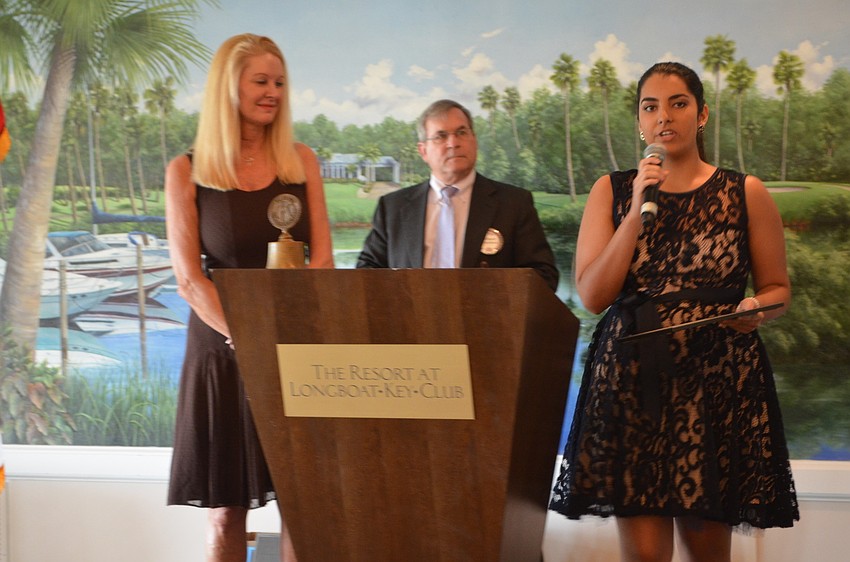 Sarah Falls, University of Florida, is awarded an academic scholarship by Scholarship Committee Chair Susan Philips and Longboat Kiwanis Club President Richard Crawford.