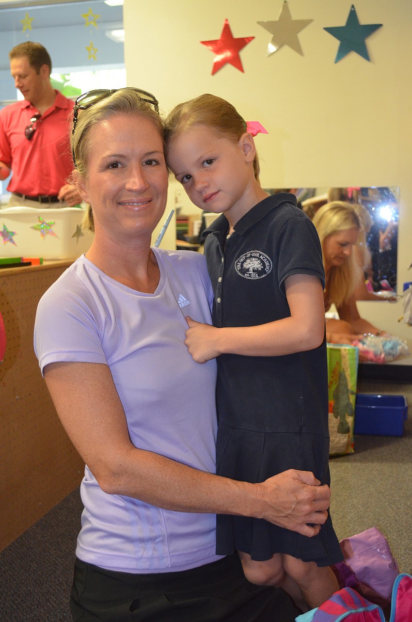 Katie Hollingsworth helps daughter, Avary, set up her new cubby.