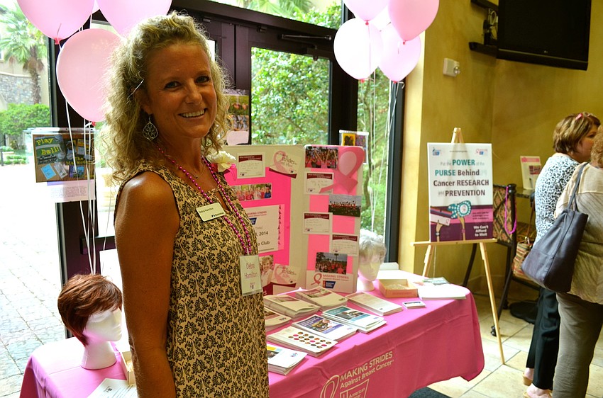 Debra Hamilton hands out breast cancer information brochures and other take-home materials.