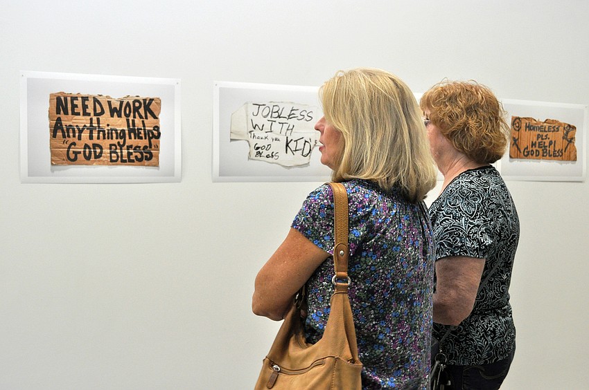 Debra Bartlett and Diana Anderson appreciate the photographs in Sally Pettibonâ€™s â€˜Flying a Signâ€™ exhibition.