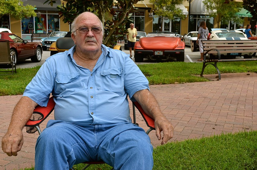 Eddie Cochran enjoys the view of rows of classic automobiles.