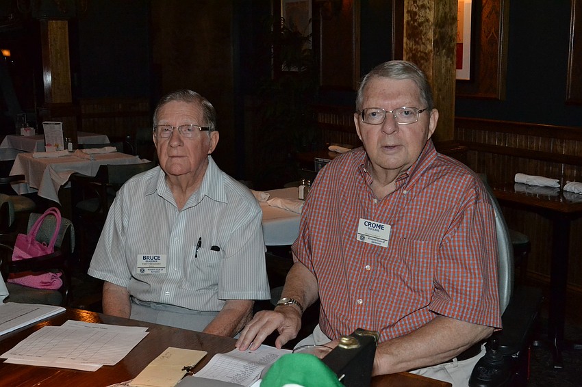 Bruce Glazener and Crome Dollase greet members for the Kiwanis club of Sarasota annual luncheon.