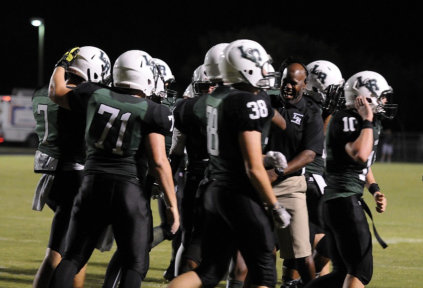 The Lakewood Ranch High defense celebrates following an interception in the end zone in the fourth quarter.