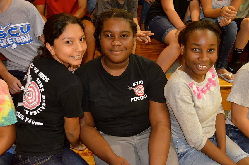 Anna Morales and Mariette Tomlinson show off their Renaissance T-shirts beside Sadoulina Edouard.