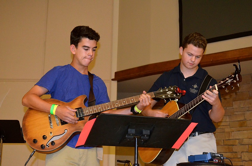 Noah King and Tronn Goehring play their guitars.