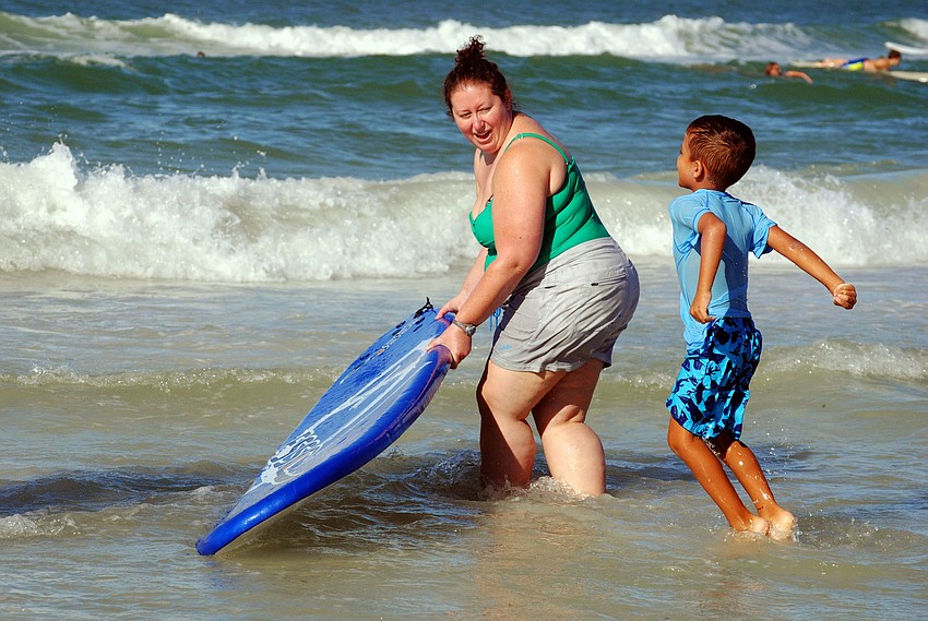 Stephanie Thomas helps an excited Luciano Iannotti get set up in the water.
