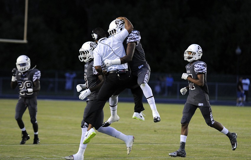 Braden River head coach Curt Bradley celebrates with linebacker Jimiah Albritton following a defensive stop late in the first half.