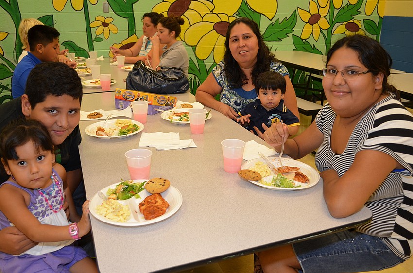 - Maria Cedillo and Maricela Cedillo enjoy dinner before playing Headbanz with Madelynn, 3, Martin, 12, and Hector, 1.