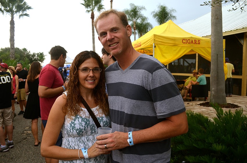 Kacie and Matt Nadeau try to stay dry during a rainy afternoon.