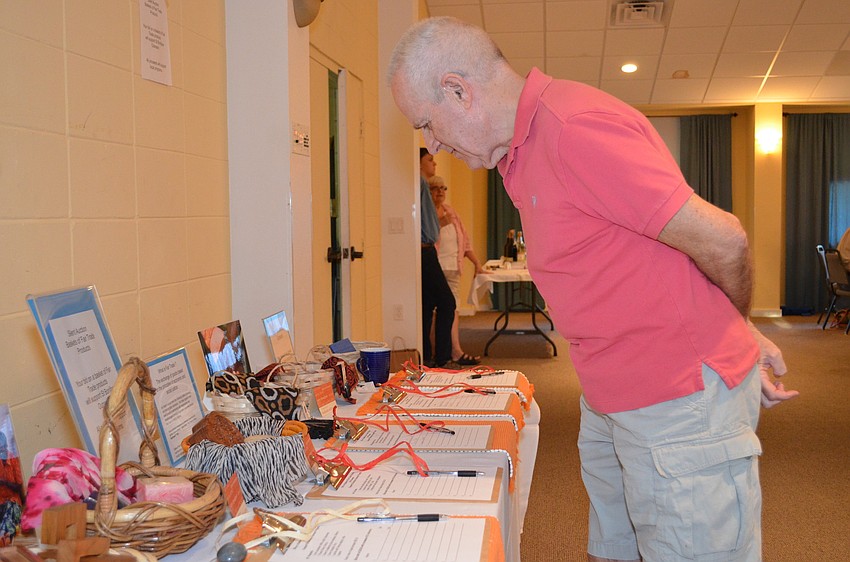 Bob Griffiths browses the items up for silent auction at the cookout.