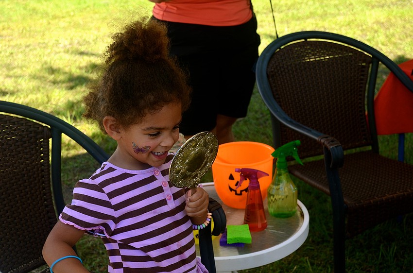 Isabella Dijiulio admires her face paint in the mirror.