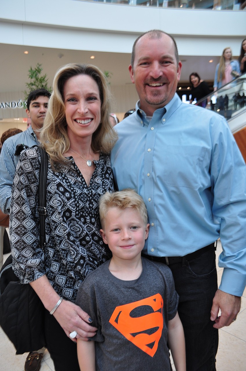Laura and Joseph Kwapis proudly pose with Scott Kwapis, right, who served as the project architect.