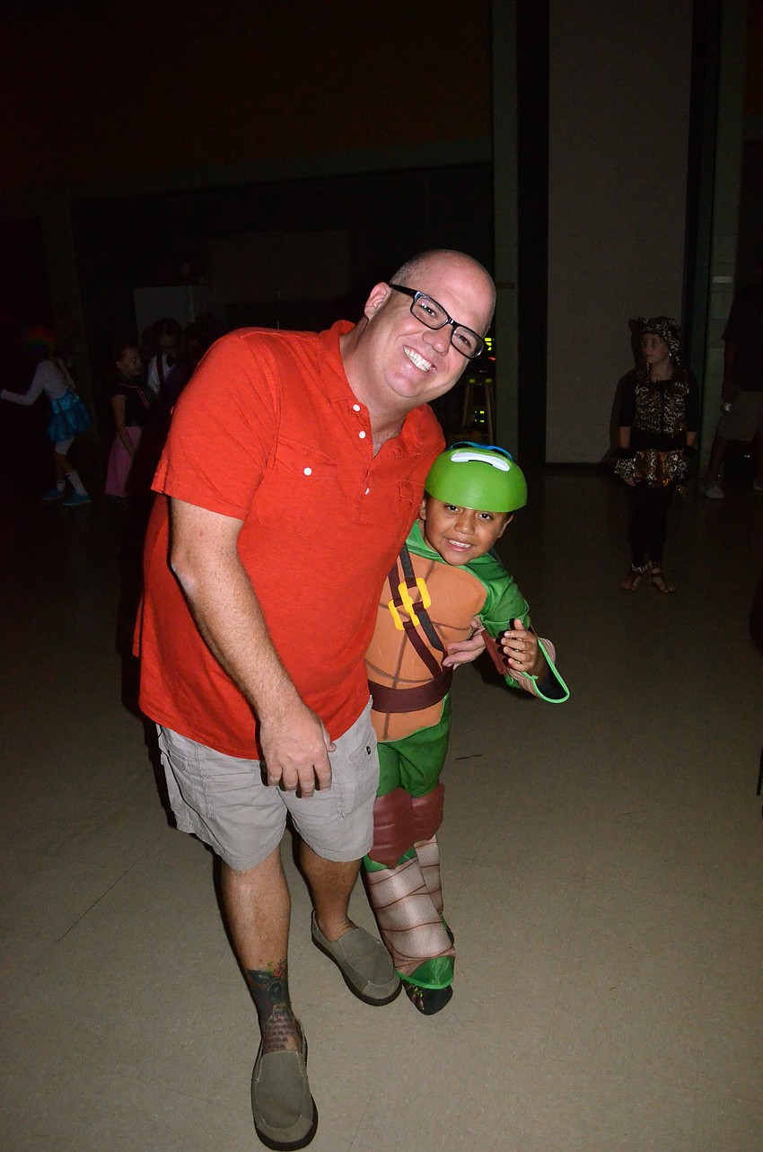Jeff Cantrell and his son, Jacob, dance to the music.
