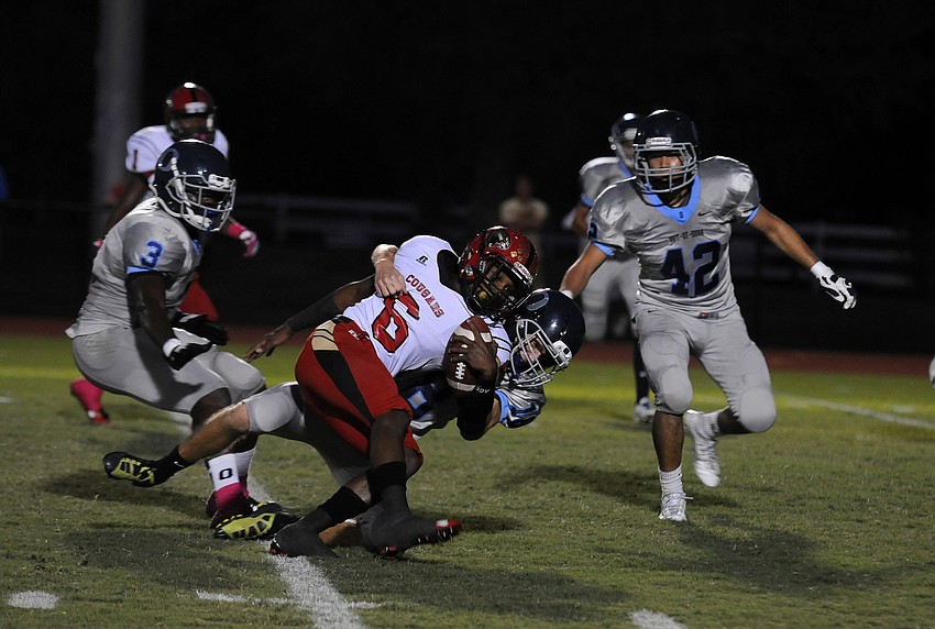 ODA defensive back Joey Runge tackles Cardinal Mooney wide receiver Sean Morris.