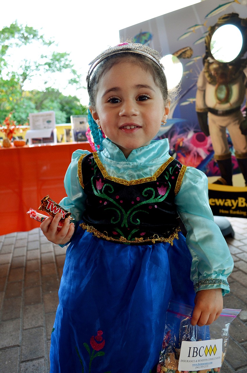 Dressed as Anna from Disneyâ€™s Frozen, Rissa Glaser trick or treats at the Mote Night of Fish, Fun and Fright.