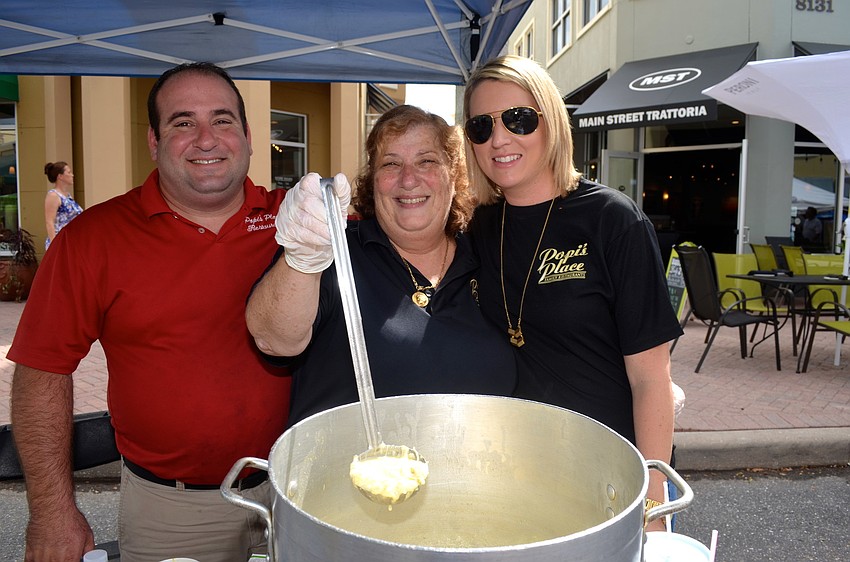 Soup-serving is a family affair with the Ameres family â€” Michael, Popi and Sarah.