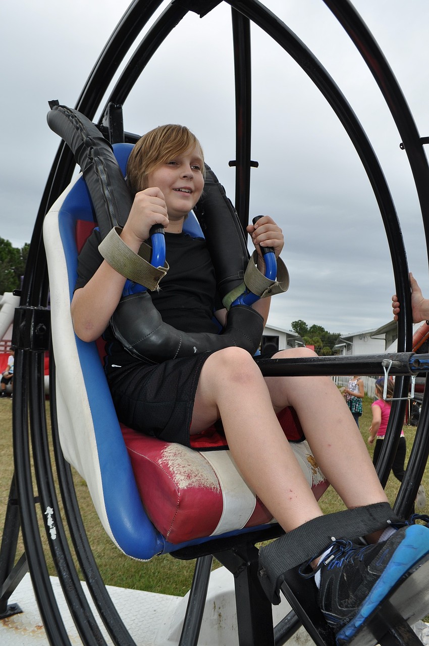 Thomas Adamson, 10, is a little dizzy after enjoying in the spaceball ride.