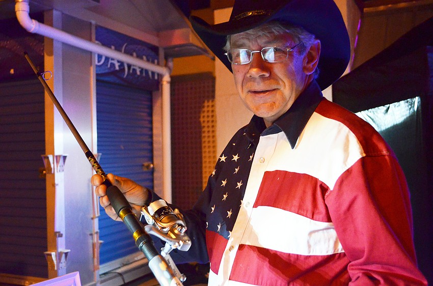 Arne Hansteen placed a bid for a fishing pole at Sandfest.