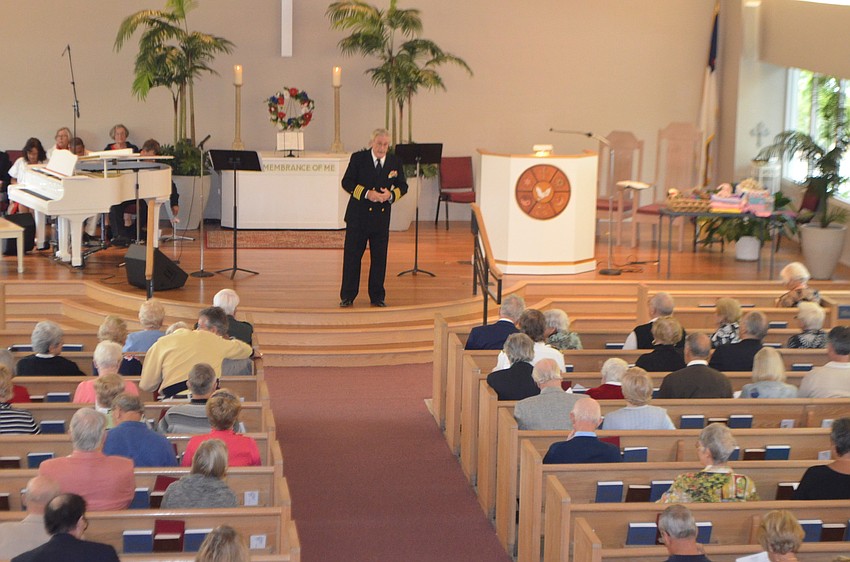 Rev. Dr. Vincent Carroll, a Navy veteran, speaks to the congregant.