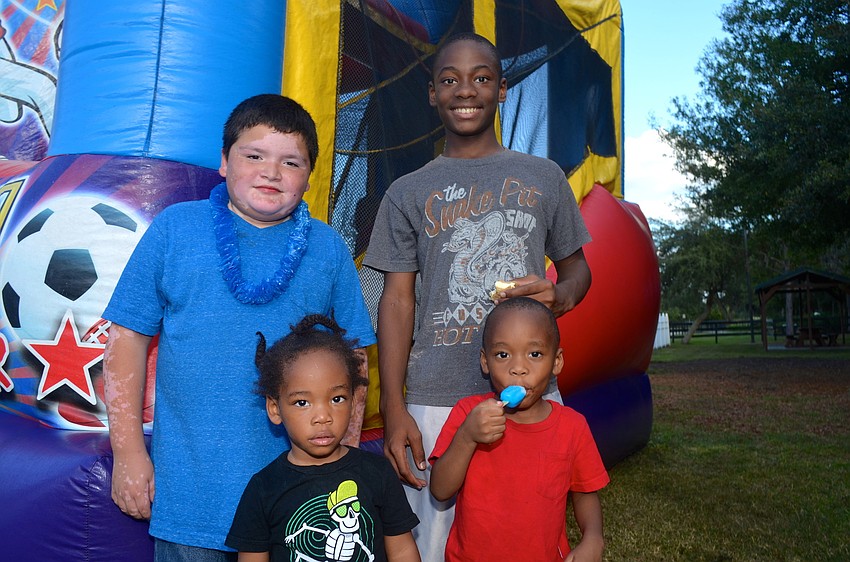 Juan Ramirez, Giovanni Saunders and Jeremias and Mathew Jean play around in the bounce house.
