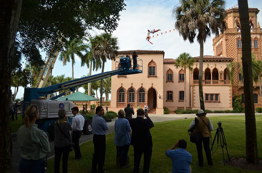 Flying and imitating the movement of a dragon kite, Li Wei is perched in the sky above the Ringling grounds.