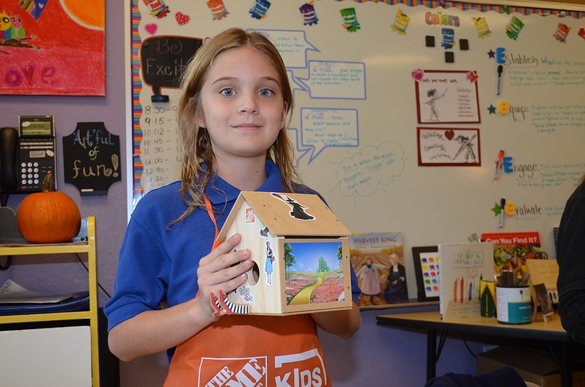 Sarah James is proud of her birdhouse.