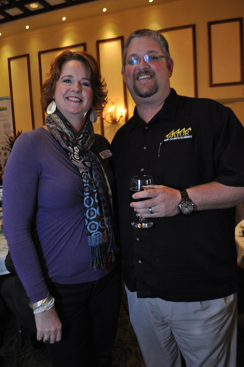 Kathleen Cucci, of Urgent Care Walk-in Centers, and Jimmy Romagnola, of Gator Air, cheer on friends.
